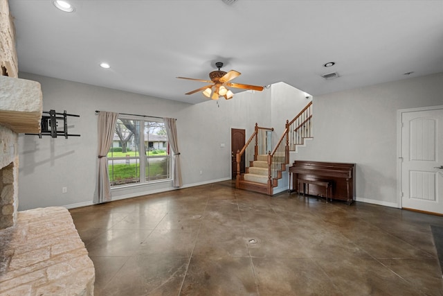 unfurnished living room with a fireplace and ceiling fan