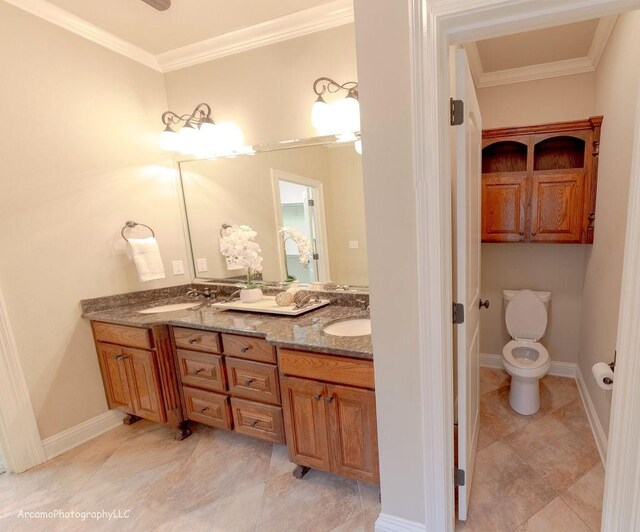 bathroom featuring ornamental molding, vanity, and toilet