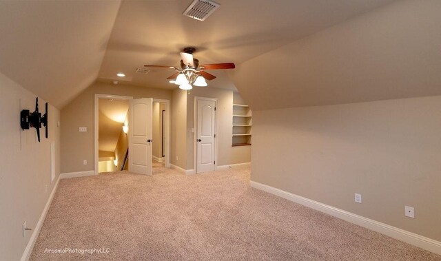 additional living space featuring light carpet, lofted ceiling, and ceiling fan