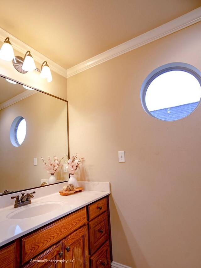 bathroom with crown molding and vanity