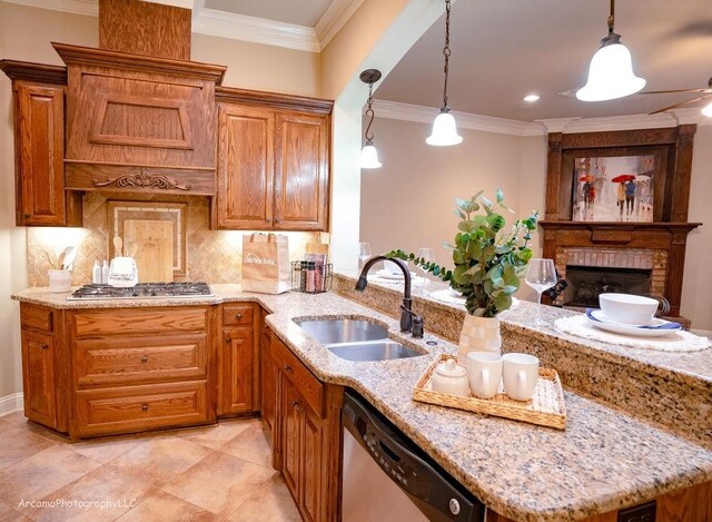 kitchen featuring appliances with stainless steel finishes, sink, pendant lighting, and ornamental molding