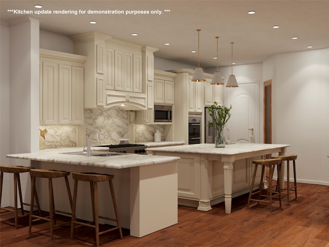 kitchen featuring a kitchen bar, stainless steel microwave, hanging light fixtures, and cream cabinetry