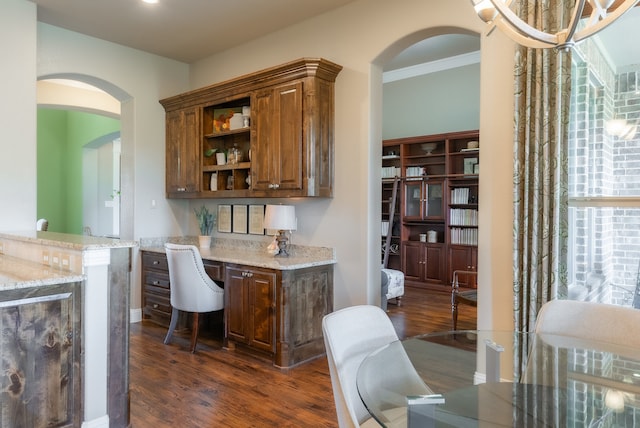 bar with crown molding, dark hardwood / wood-style flooring, and light stone counters