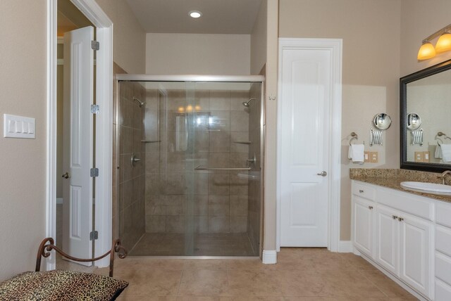 bathroom featuring vanity, tile patterned floors, and an enclosed shower