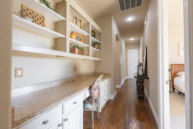 corridor featuring dark hardwood / wood-style flooring