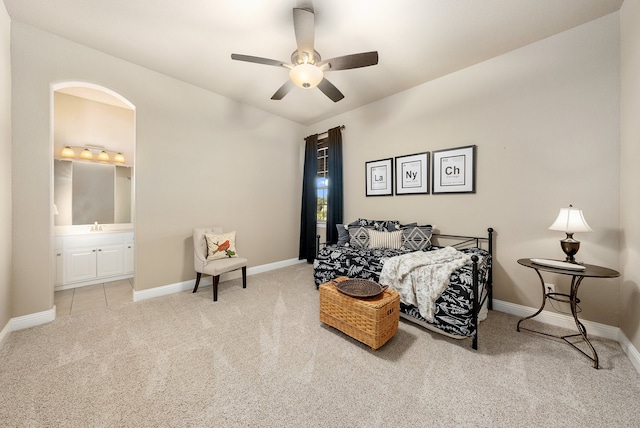 carpeted bedroom featuring ensuite bathroom, ceiling fan, and sink