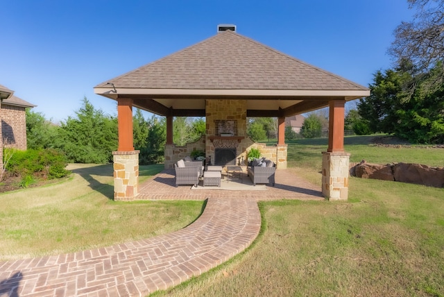 exterior space featuring a gazebo, an outdoor stone fireplace, and a patio