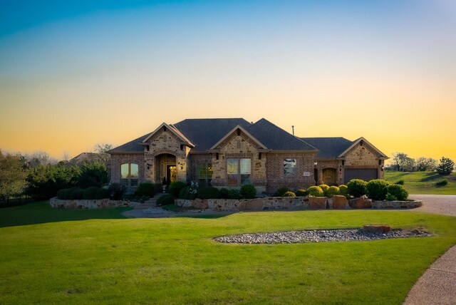 view of front of property with a lawn and a garage