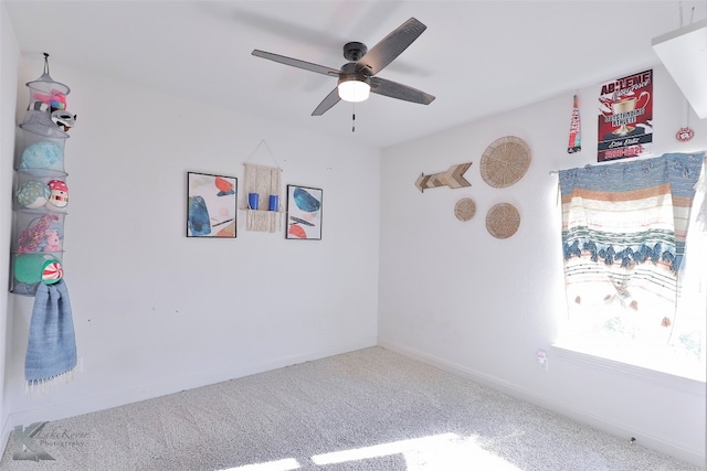 unfurnished room with ceiling fan and light colored carpet