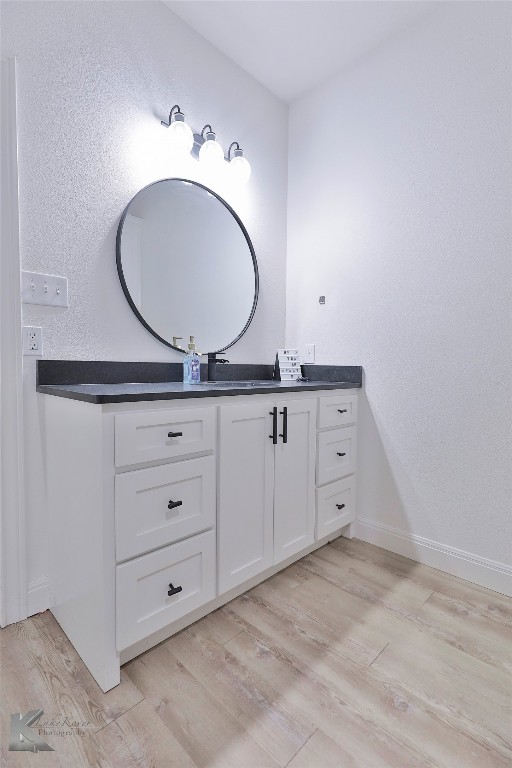 bathroom with wood-type flooring and vanity