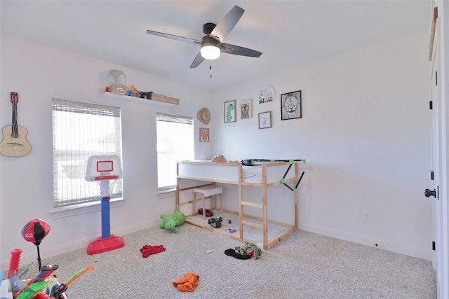 rec room featuring light colored carpet and ceiling fan