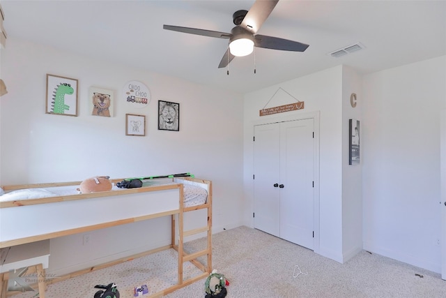 bedroom with light carpet, a closet, and ceiling fan