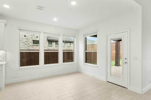 unfurnished sunroom featuring a healthy amount of sunlight