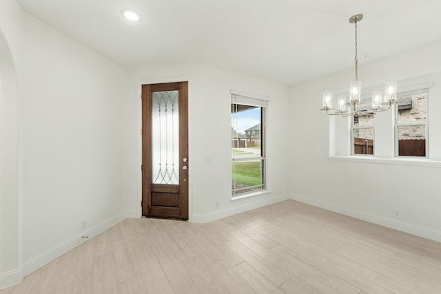 entrance foyer featuring a notable chandelier and light hardwood / wood-style floors