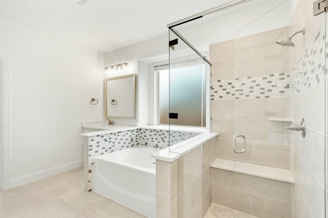 bathroom featuring vanity, tile floors, and plus walk in shower