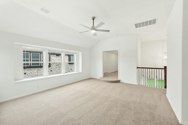 carpeted empty room featuring ceiling fan and lofted ceiling