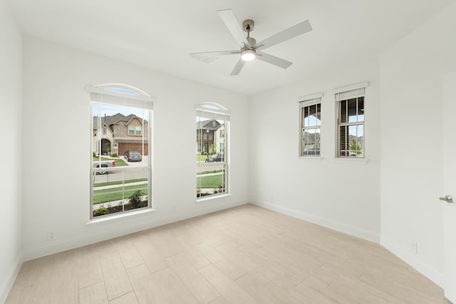 empty room featuring ceiling fan and light hardwood / wood-style flooring