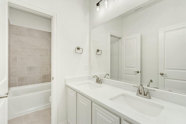 full bathroom featuring dual bowl vanity, tile flooring, shower / bath combination, and toilet