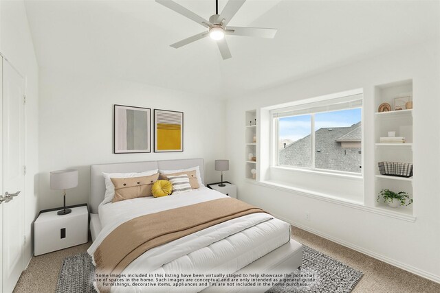 carpeted bedroom with ceiling fan and lofted ceiling