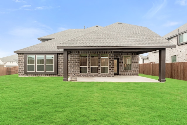 back of property featuring a lawn and a patio area