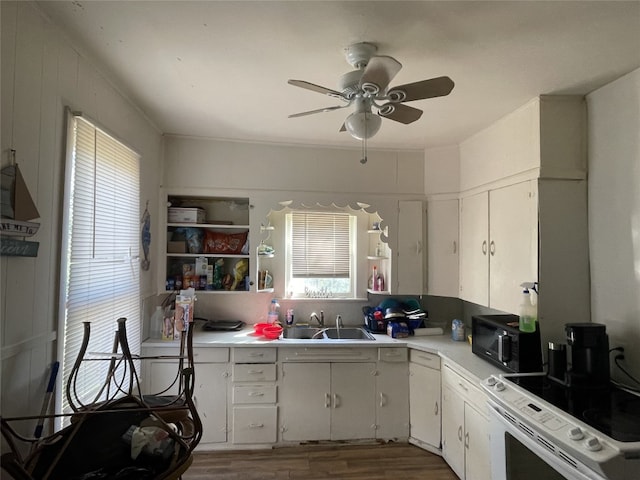 kitchen with white range oven, sink, ceiling fan, and dark hardwood / wood-style flooring