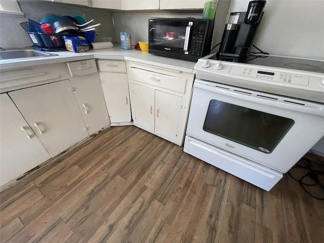 kitchen with white electric range, dark hardwood / wood-style floors, and white cabinetry