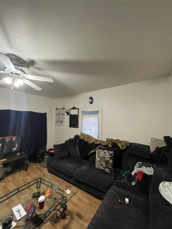 living room featuring a textured ceiling, ceiling fan, and wood-type flooring