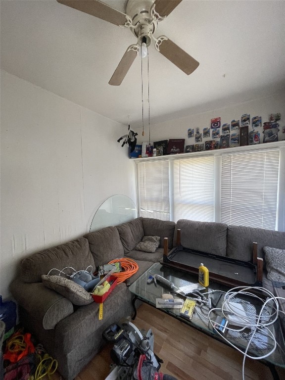 living room featuring wood-type flooring and ceiling fan