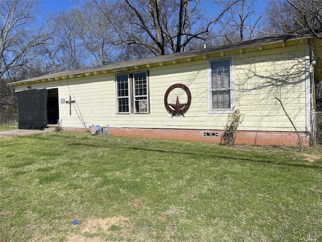 view of side of property with a lawn