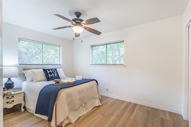 bedroom with ceiling fan and light hardwood / wood-style flooring