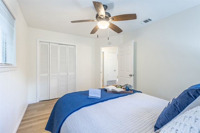 bedroom featuring a closet, light wood-type flooring, and ceiling fan