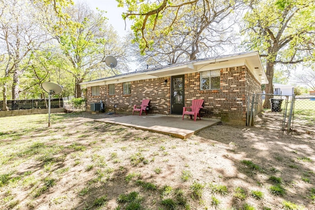 rear view of property with cooling unit and a patio