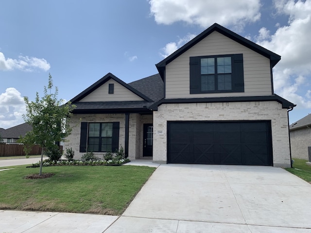 view of front of home featuring a front yard and a garage