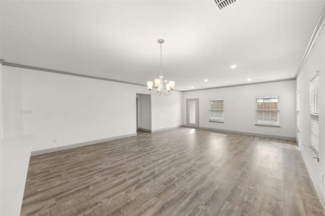 interior space featuring wood-type flooring, crown molding, and a chandelier