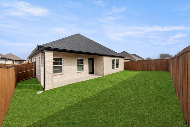 rear view of house featuring a patio and a yard