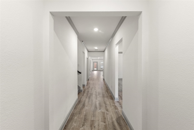 hall featuring light hardwood / wood-style flooring and crown molding