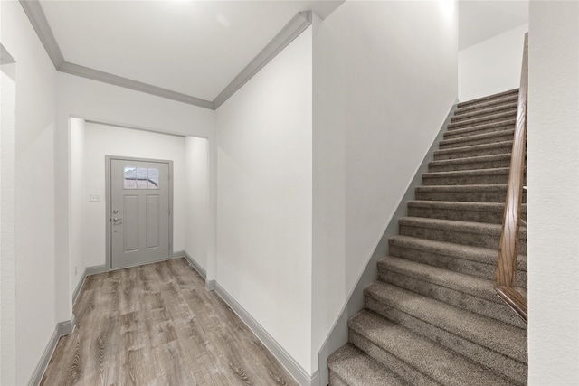 entrance foyer featuring light hardwood / wood-style flooring and ornamental molding