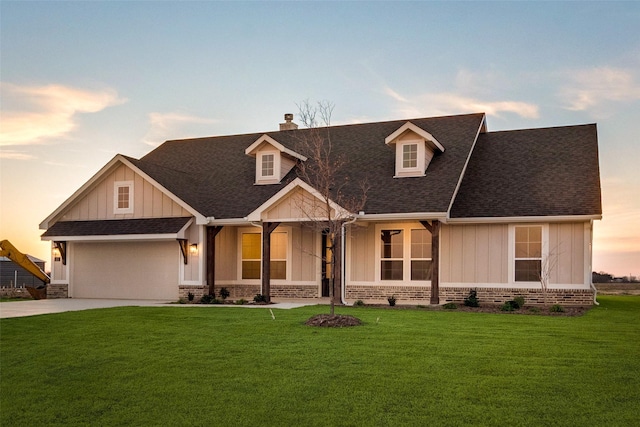 view of front facade with a yard and a garage