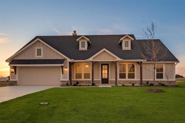 view of front of home with a yard and a garage