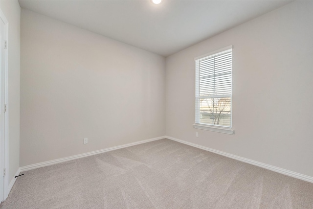 unfurnished room featuring light carpet