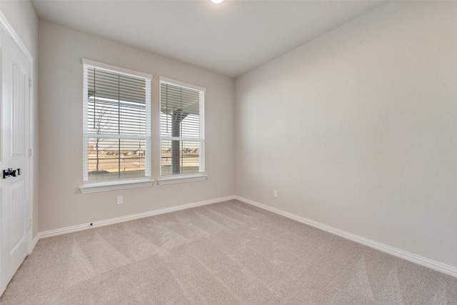 unfurnished room with light carpet