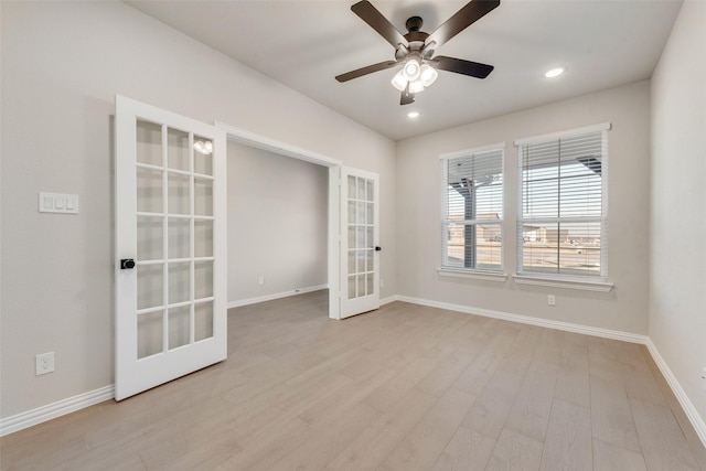 spare room featuring ceiling fan, light hardwood / wood-style floors, and french doors