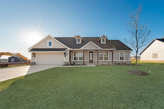 view of front of home with a garage and a front lawn