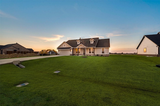 view of front facade featuring a lawn and a garage