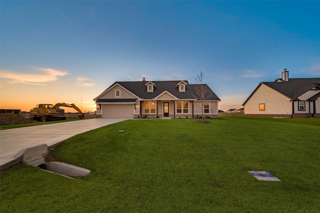 view of front of home with a lawn and a garage