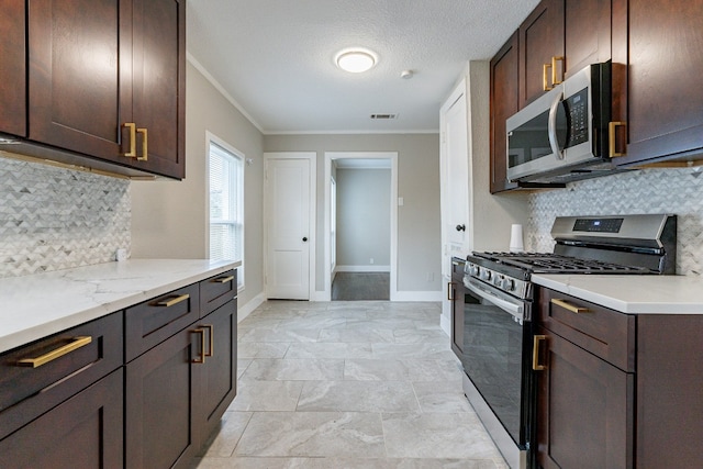 kitchen featuring backsplash, appliances with stainless steel finishes, light tile floors, and light stone counters