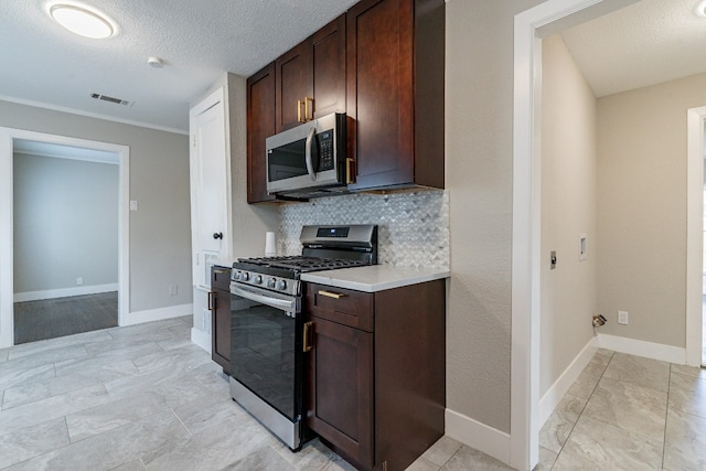 kitchen featuring backsplash, appliances with stainless steel finishes, light tile floors, a textured ceiling, and dark brown cabinetry