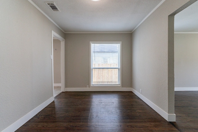 unfurnished room featuring a textured ceiling, ornamental molding, and dark hardwood / wood-style floors