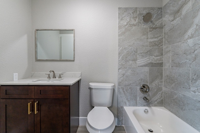 full bathroom featuring tiled shower / bath combo, toilet, and vanity