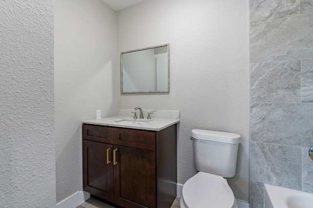 bathroom featuring toilet and vanity